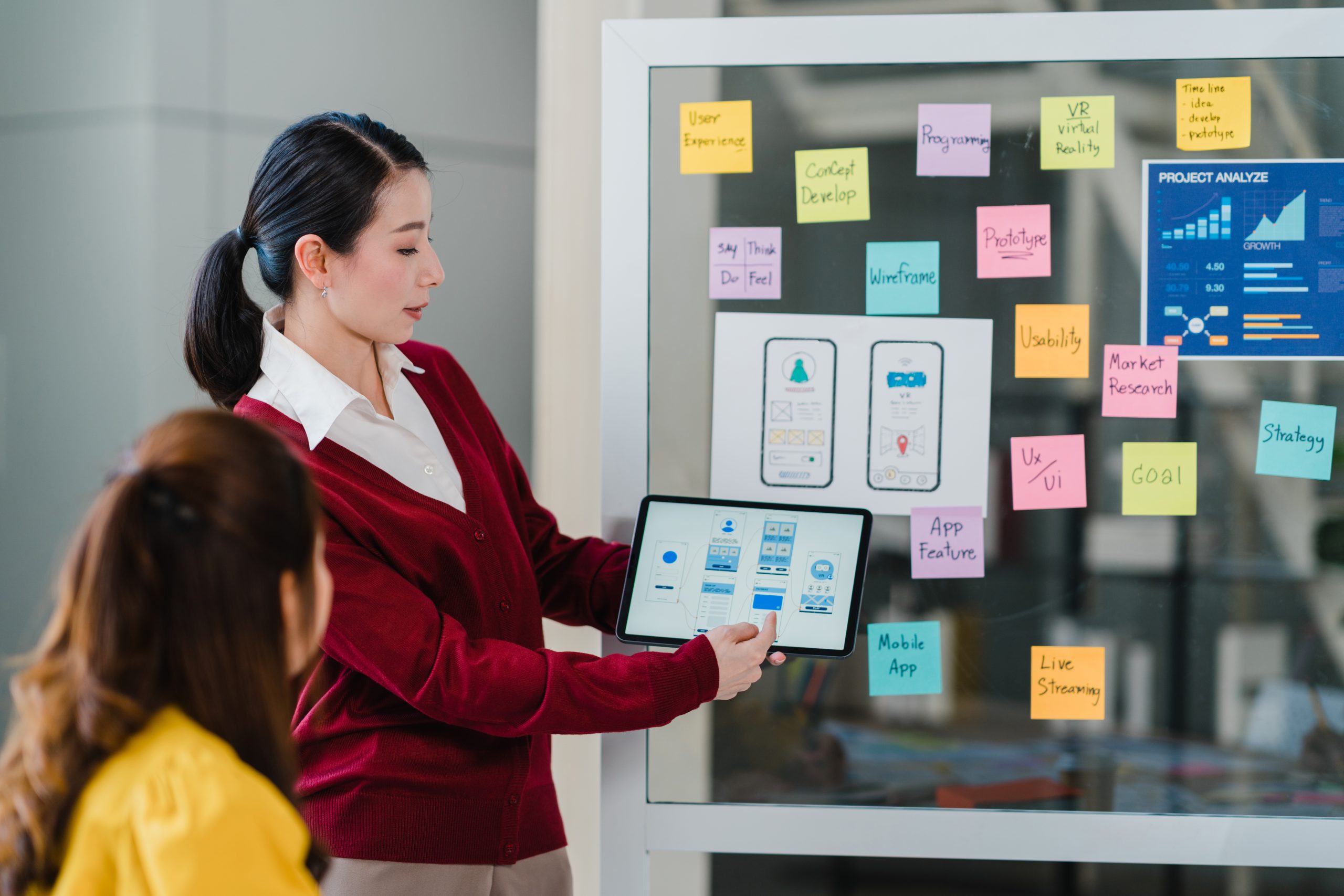 Group of Asia young creative people meeting brainstorming ideas conducting business presentation ideas mobile application software design project colleagues in modern office. Coworker teamwork concept