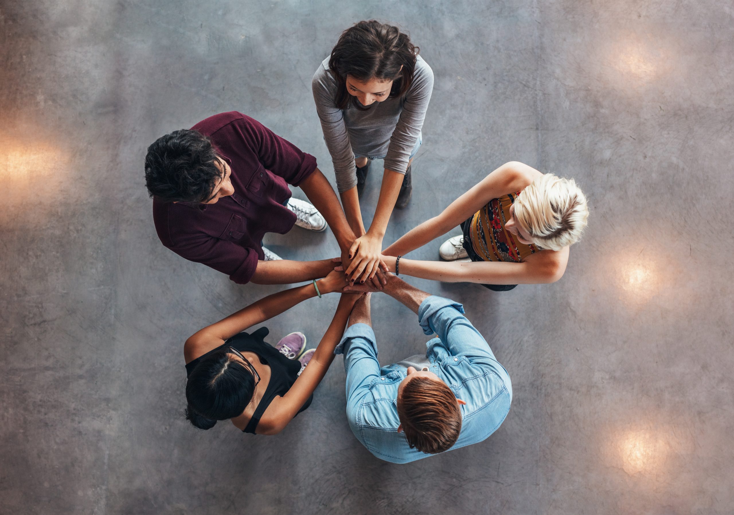 Young people making a stack of hands